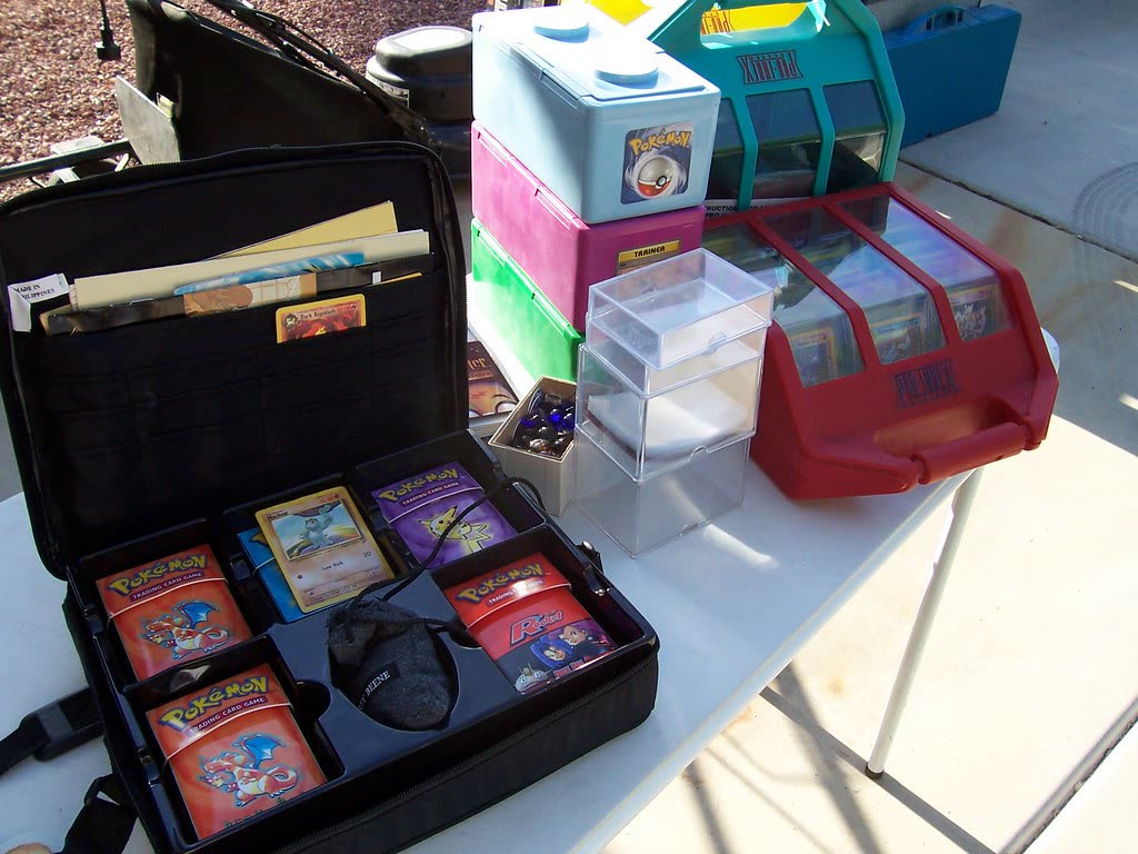 Pokémon card storage cases and carrying case on a table